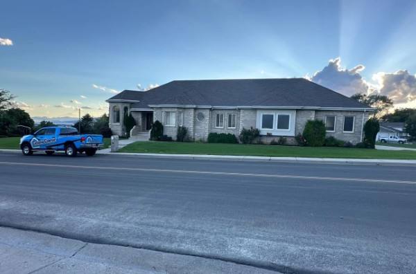 Tarp covering storm damage on a residential roof after a wind event